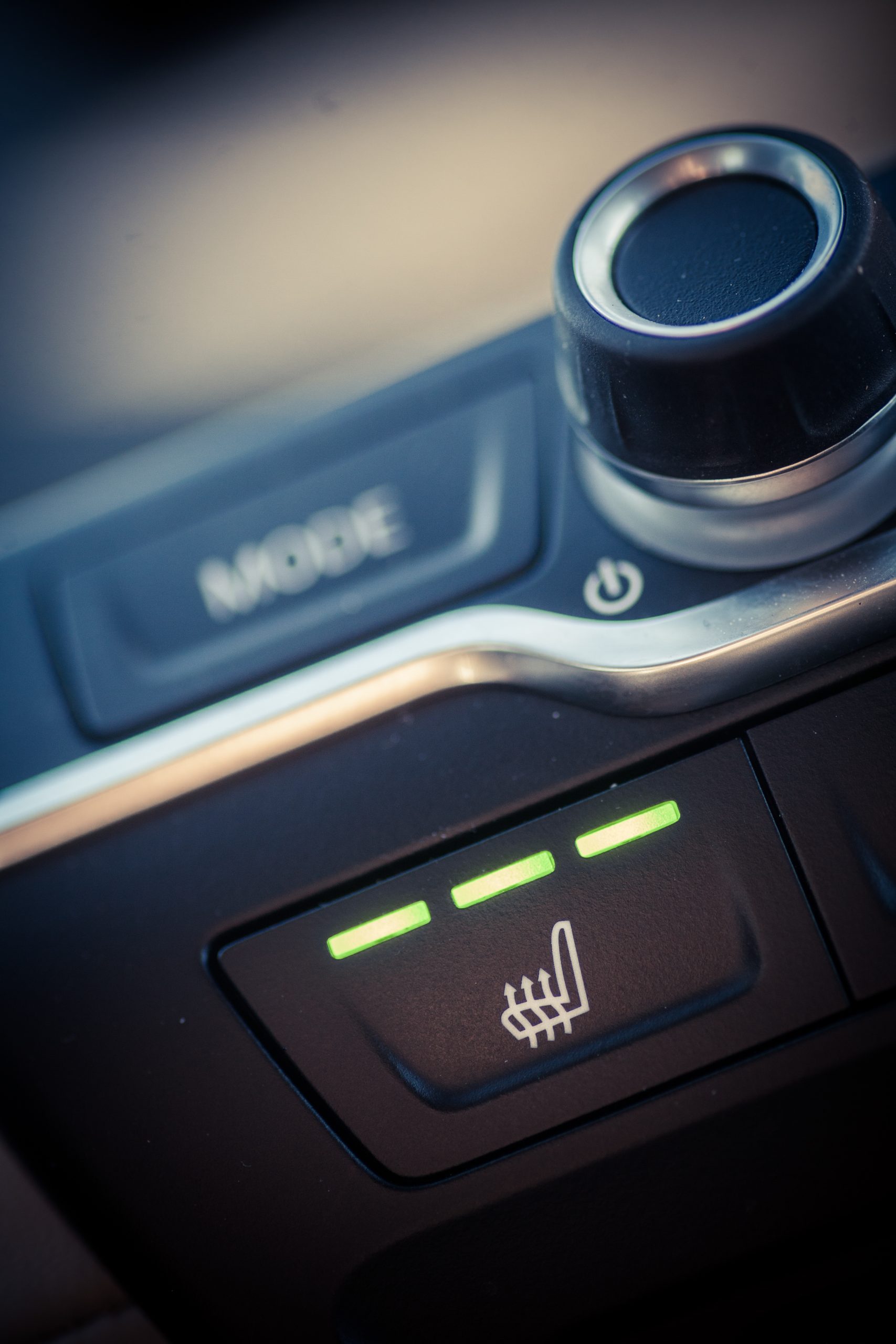 Close up shot of a car's heated seats button.